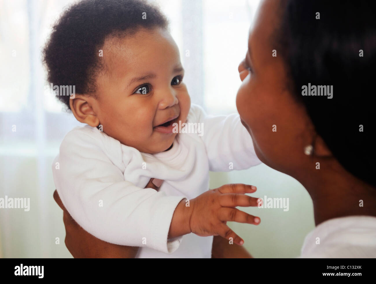 Mother holding her baby up to her face. Cape Town, South Africa Stock Photo