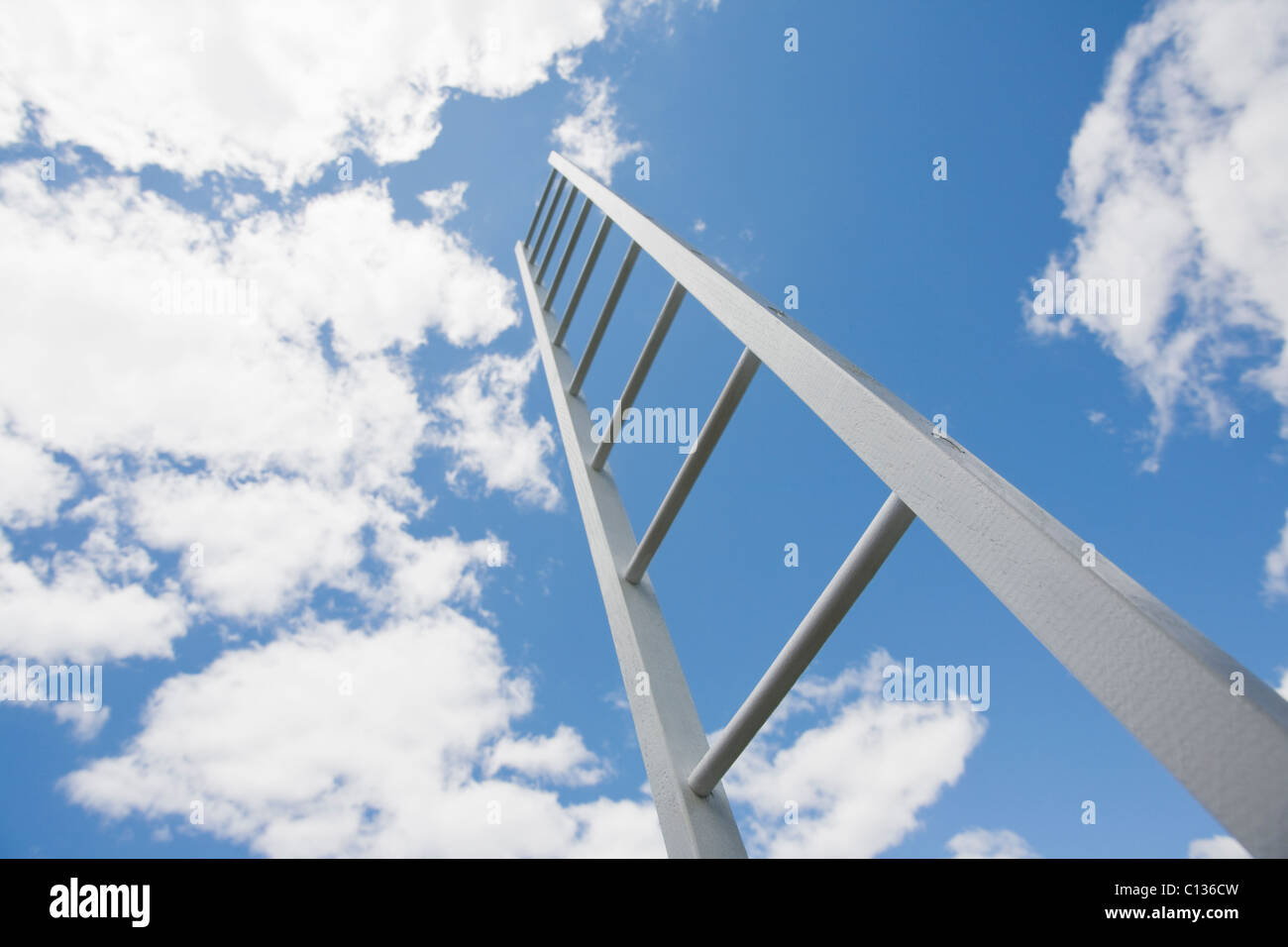 USA, New Jersey, ladder reaching cloudy sky Stock Photo