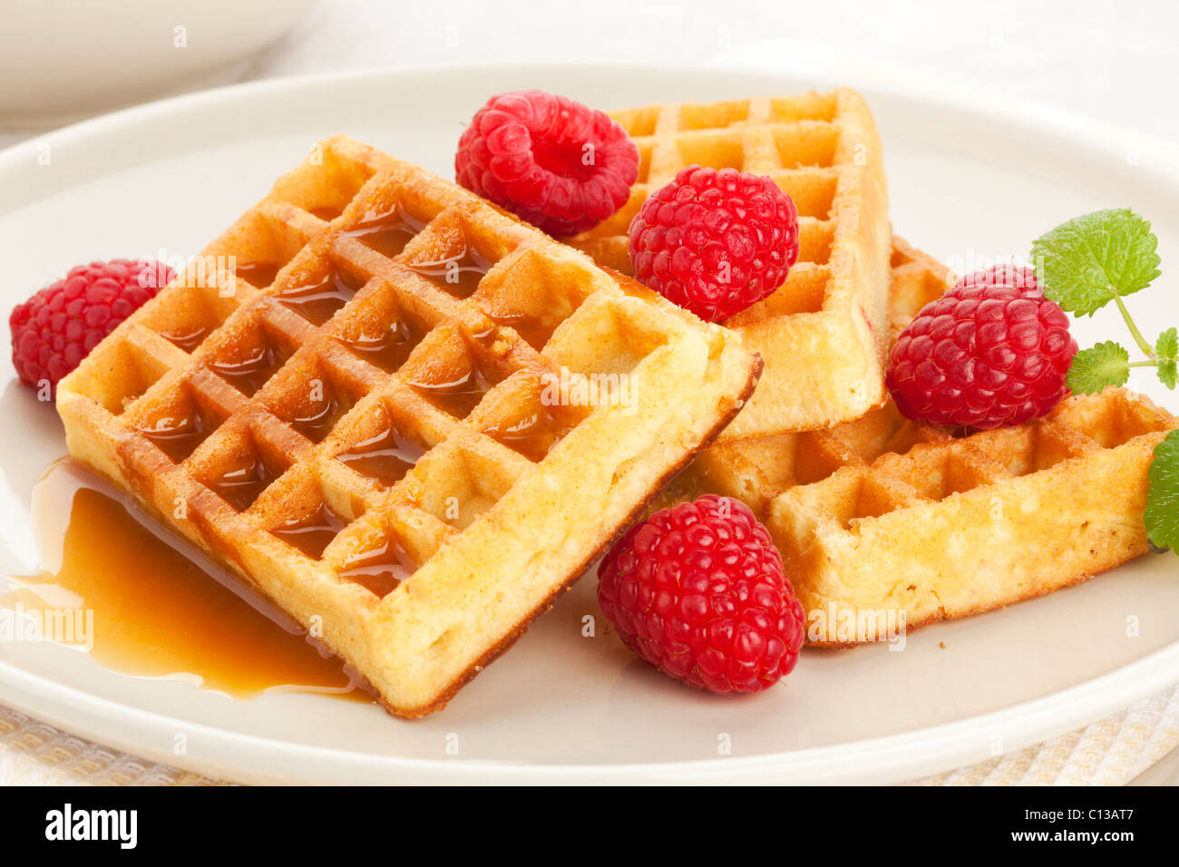 belgian waffles with raspberries and caramel sauce Stock Photo