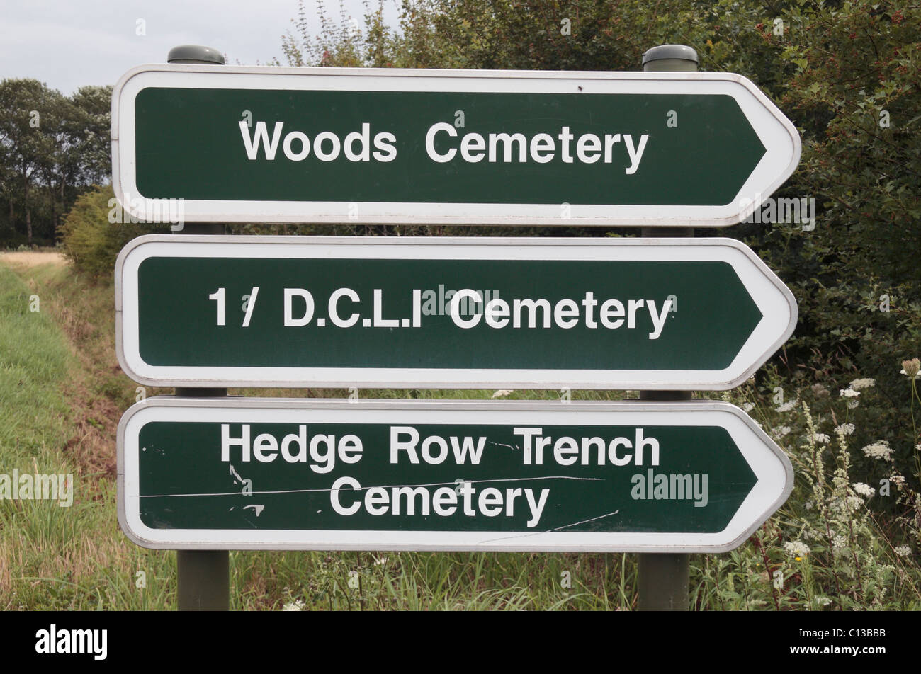 Direction signposts to three Commonwealth War Graves Commission (CWGC) in near Ieper (Ypres), Belgium. Stock Photo