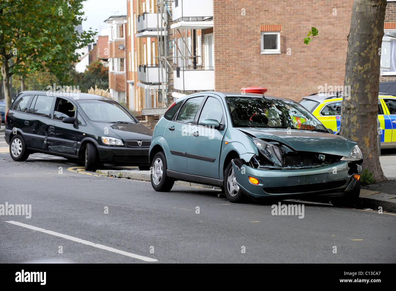 Two cars damaged at the side of the road after a small accident Stock Photo