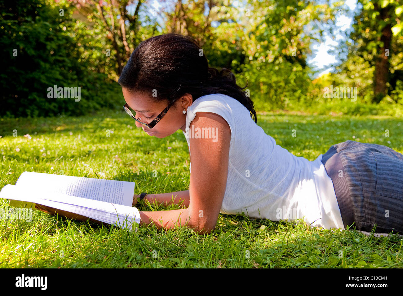 Young Student reading books at the school park Stock Photo