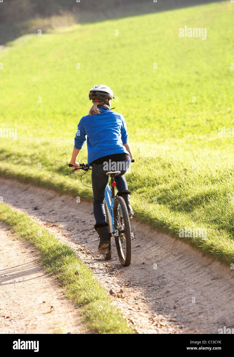 Back view woman rides bicycle hi-res stock photography and images - Alamy