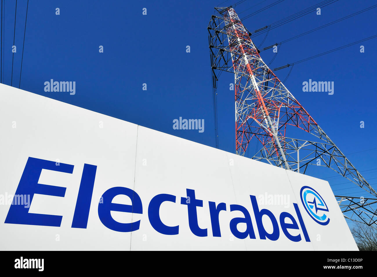 Electricity high-tension pylon and sign with logo of energy corporation Electrabel, Ghent, Belgium Stock Photo