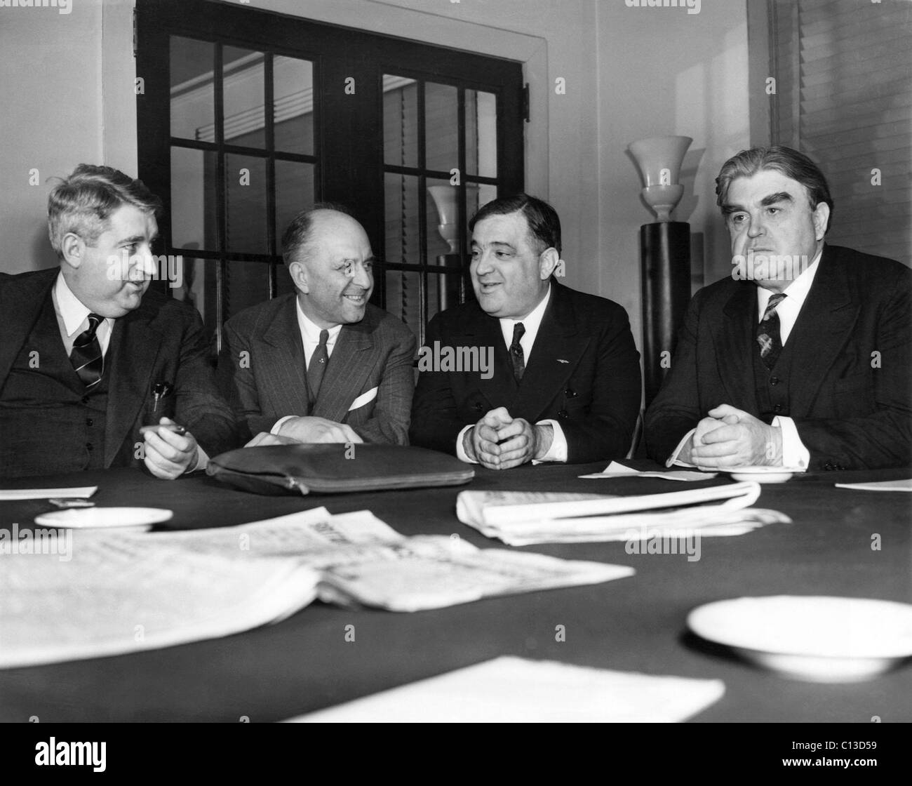 New York Mayor Fiorello LaGuardia urges coal miners and operators to negotiate a speedy settlement of a new union contract to avert a coal shortage in New York City. From left: management spokesman Charles O'Neill, conference chairman Walter Robison, LaGuardia, United Mine Workers and C.I.O. head John L. Lewis, New York City, April 13, 1939 Stock Photo