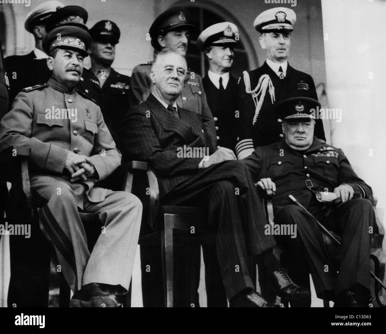 World War II. From left, front row: Soviet Premier Josef Stalin, US President Franklin Delano Roosevelt and British Prime Minister Winston Churchill at the Tehran Conference. Back row, left of Stalin: US General Henry Harley Arnold. Back row, second from right: British Admiral Sir Andrew Browne Cunningham. Back row, far right: US Admiral William Leahy Stock Photo