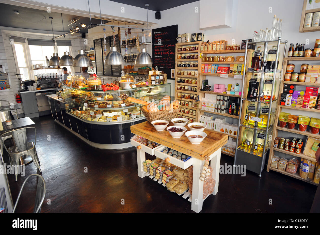 An array of mouthwatering foods on display in Artisan delicatessen shop in Brighton Stock Photo