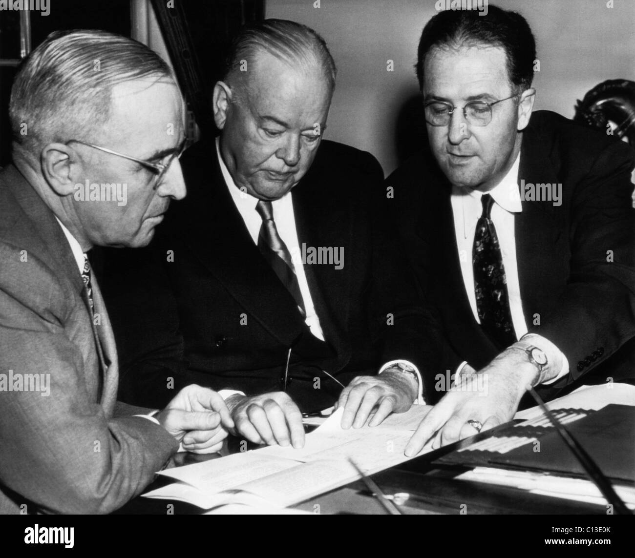 President Harry Truman, confers with Former President Herbert Hoover, and Secretary of Agriculture Clinton P. Anderson, as Hoover delivers his round-the-world food survey at the White House, Washington DC, May 13, 1946. Stock Photo