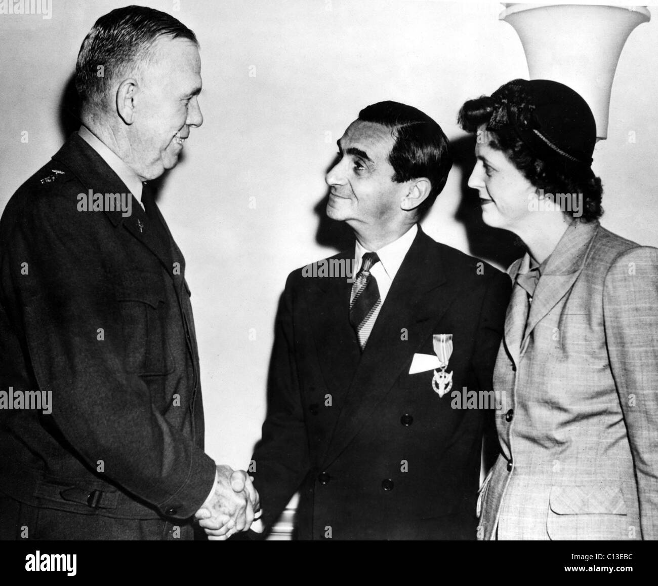 Irving Berlin is presented with the Medal For Merit by General George C. Marshall as Mrs. Berlin watches on. Pentagon, Washington, D.C., 10-01-1945. Stock Photo