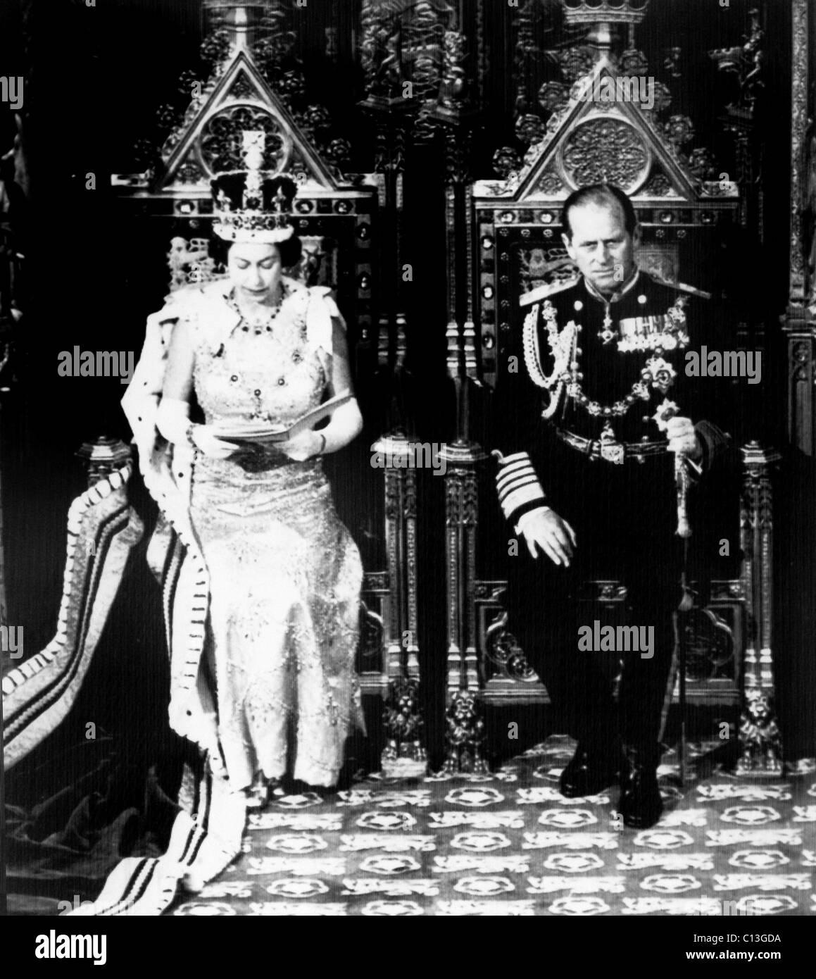 Queen Elizabeth II, and her husband and consort, Prince Philip, as the Queen announces that the Labor government will nationalize Britain's shipbuilding and aircraft industries, during the opening of Parliament in the Chamber in the House of Lords, October 29, 1974. Stock Photo