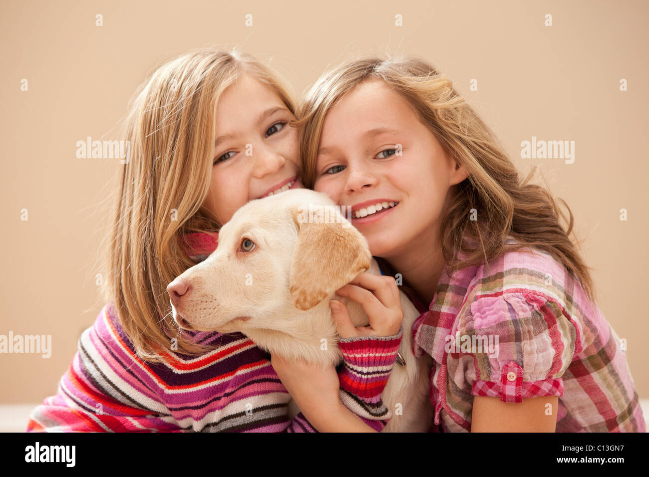 USA, Utah, Lehi, Portrait of two girls (10-11) embracing Labrador Stock Photo