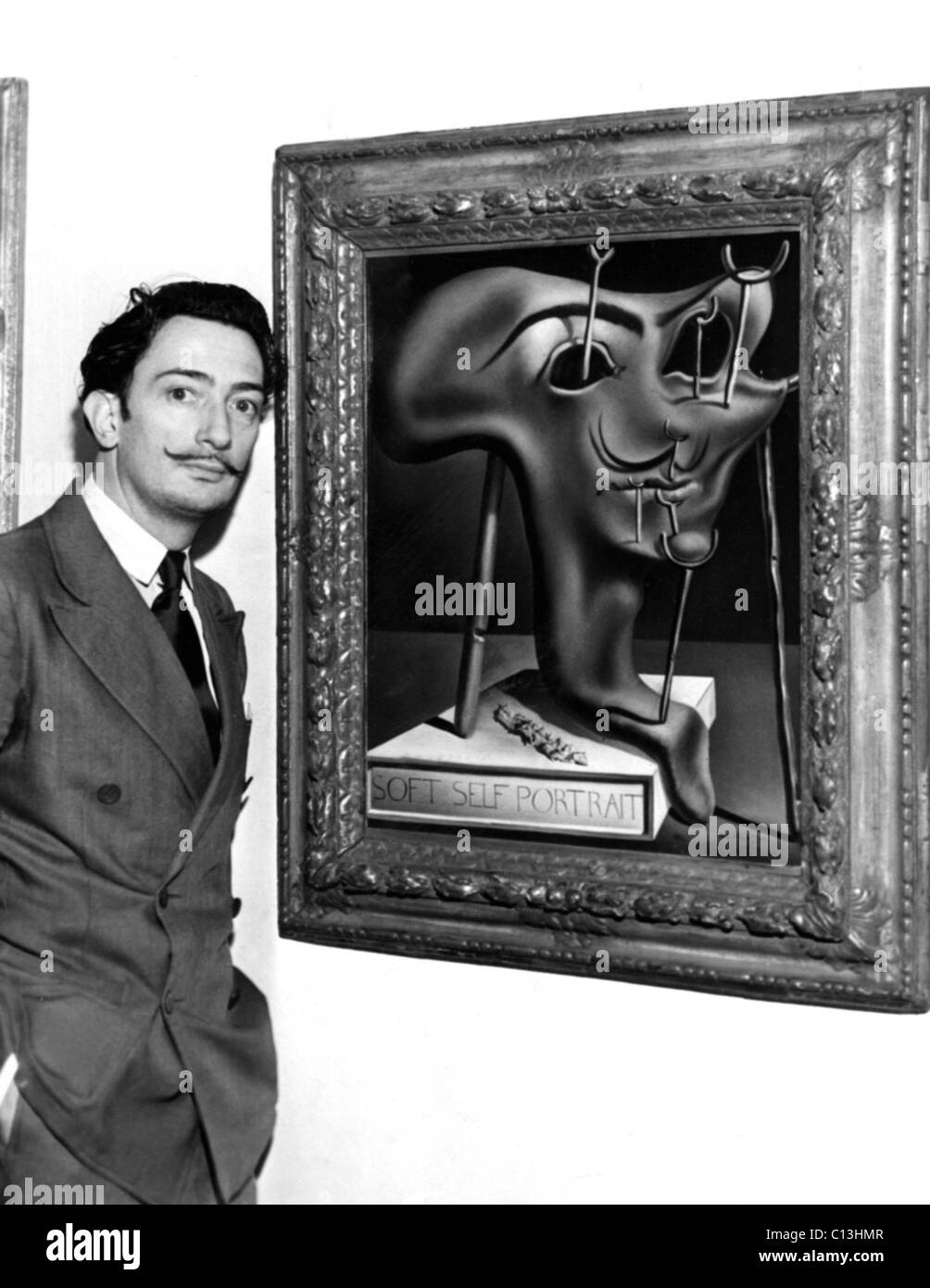 Salvador Dali, showing off his piece entitled 'Soft Self Portrait' at the Julien Levy Gallery in New York, ca. 1941 Stock Photo