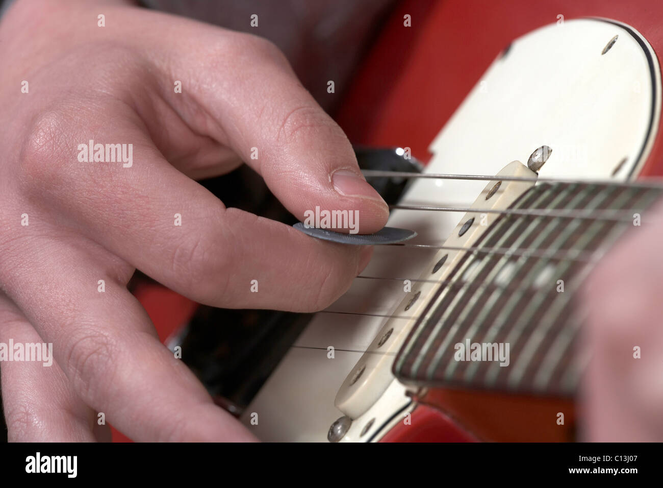 Playing electric guitar. Looking down the neck and playing with a