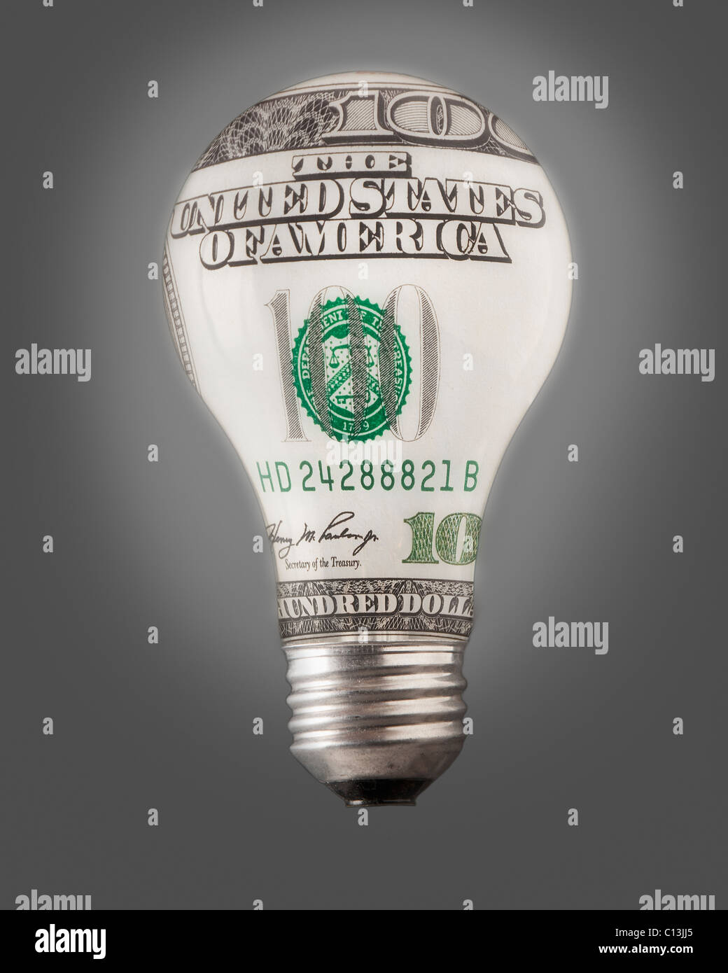 Composition of bulb and one hundred dollar note Stock Photo