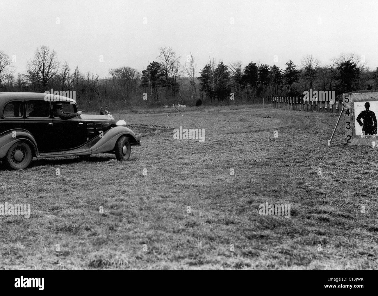 FBI agents honed their gun skills by target practice from speeding cars in order to keep up with the motorized Depression era bandits infesting the Mid-West. Ca. 1935. Stock Photo