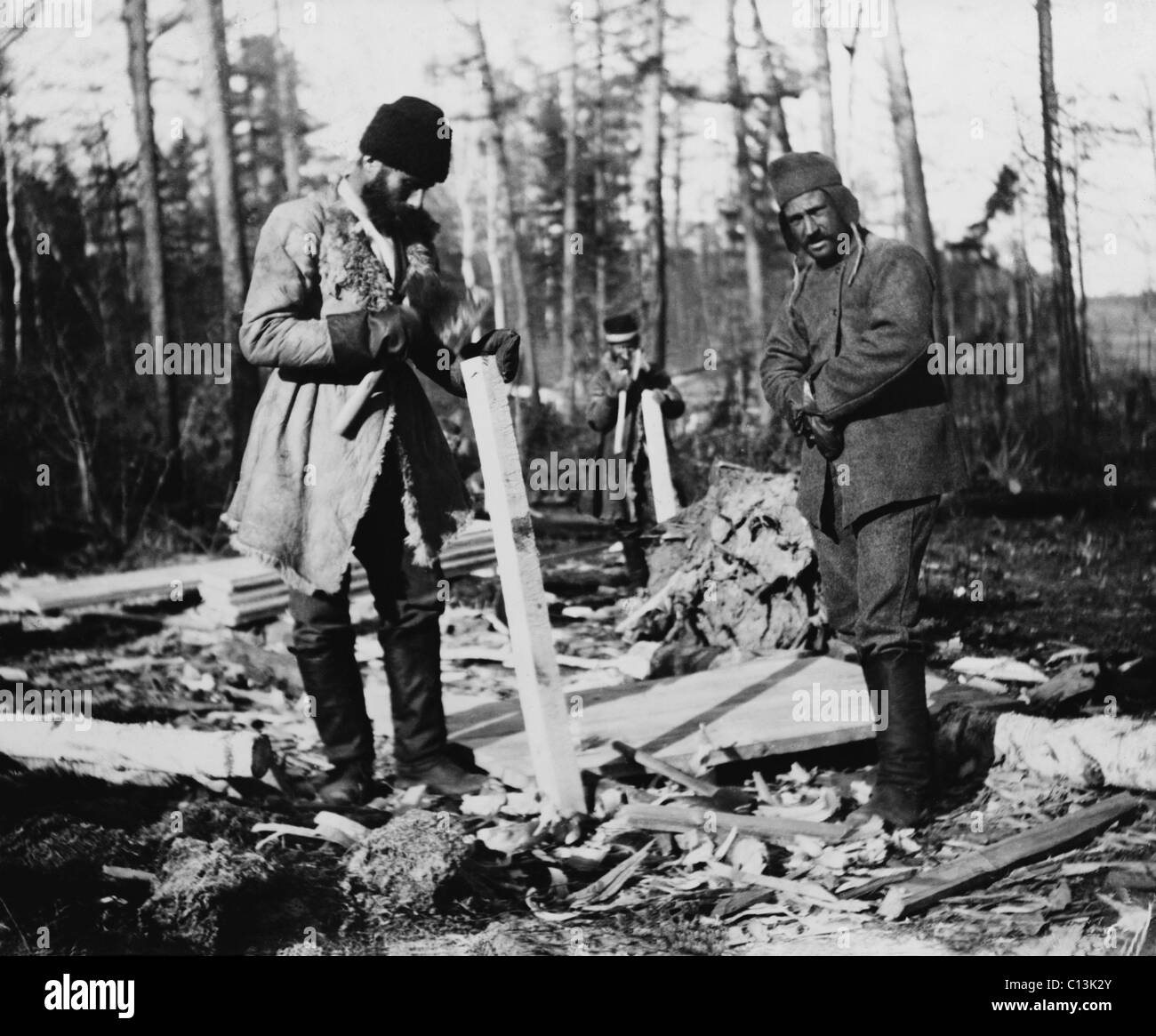 Three Russian convicts building a camp near the Eastern Siberian Railroad. Throughout the 19th century, Russia populated its easternmost territories with political and criminal prisoners. Ca. 1895 photo by William Henry Jackson. Stock Photo