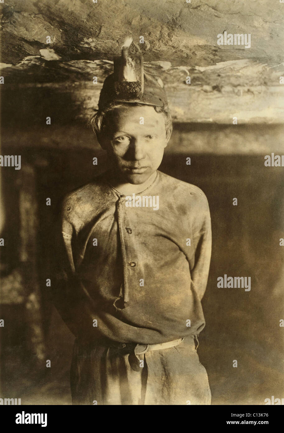 A Trapper Boy, whose job was to wait in the dark mine, opening and