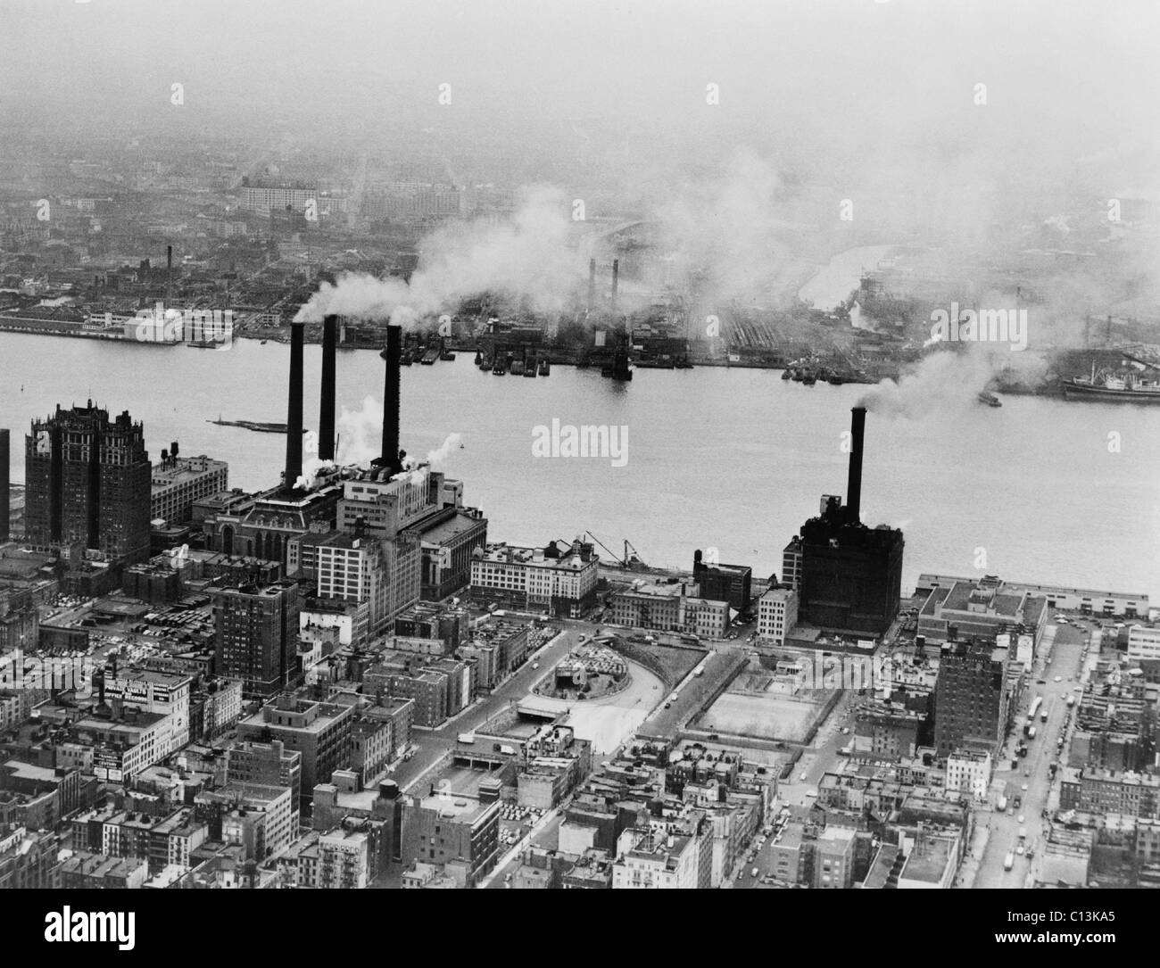 Smoke issues from stacks of Con Edison's coal powered electricity generating plant on the East River. New York City, February 15, 1951. Stock Photo