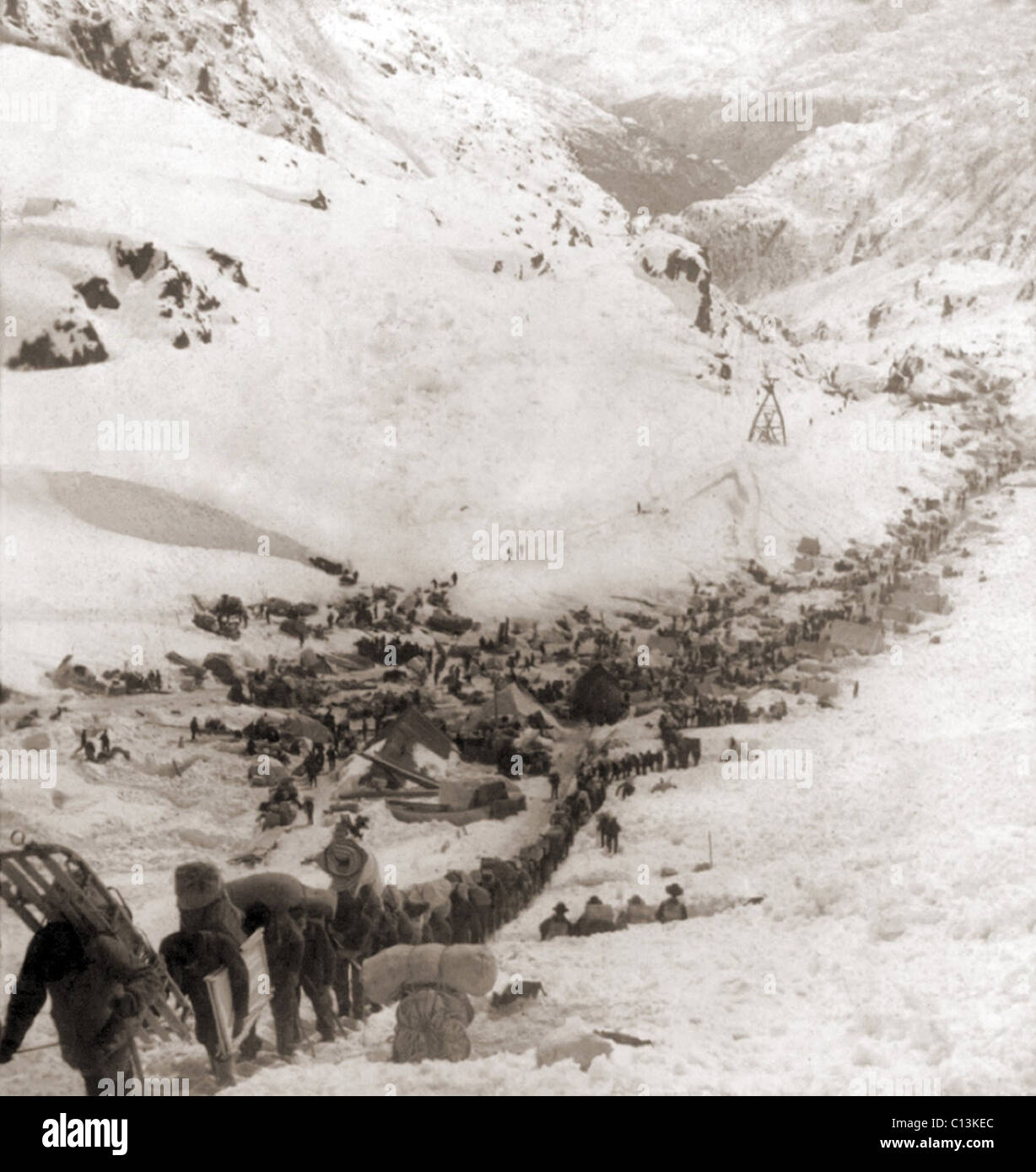 Long ribbon of miners bound for the Klondike gold fields climbing over the Chilcoot Pass, in 1898. Stock Photo