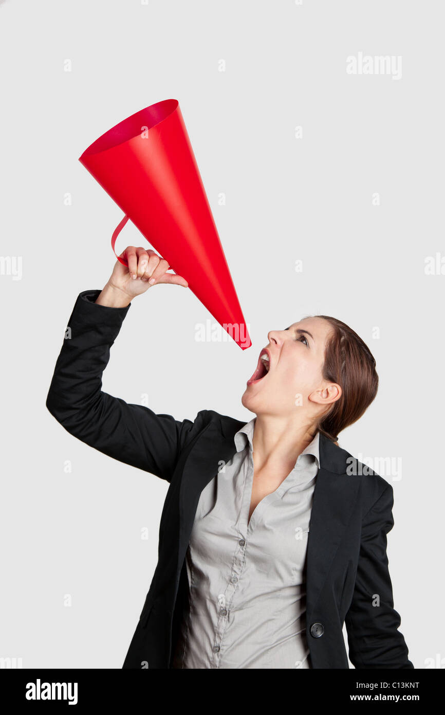 Business young woman speaking to a megaphone, isolated on white Stock Photo