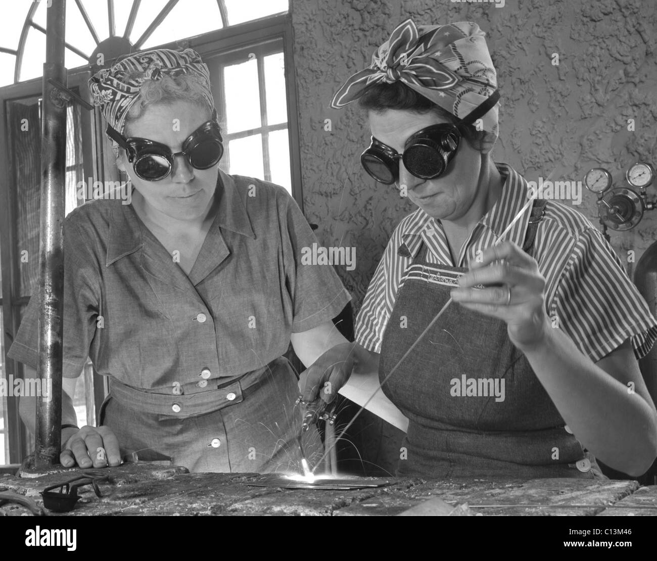 Two Daytona Beach, Florida, housewives welding in an Aircraft construction class during World War II. Both have sons in the military. April 1942. Stock Photo