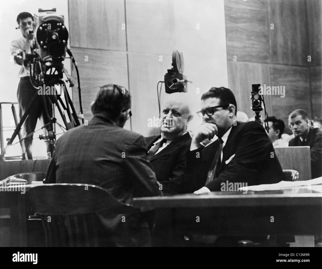 Television cameras filming Billie Sol Estes right conferring with his attorneys during his fraud trial for receiving millions of agricultural subsidies. The highly connected Texas Democrat successfully argued that camera coverage of the trial deprived Stock Photo