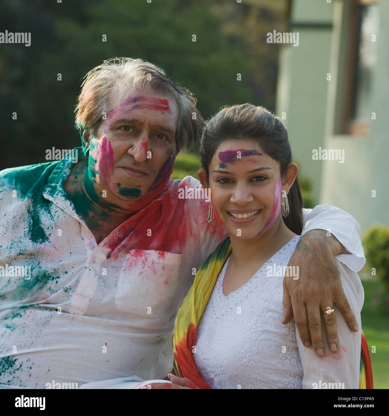 Portrait of a woman celebrating Holi with her father Stock Photo