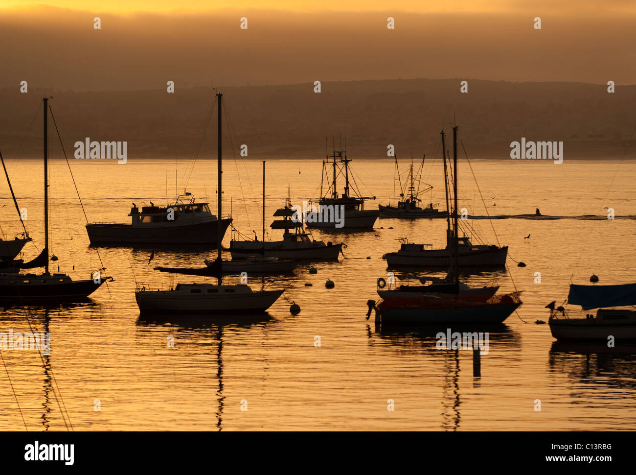 Silhouette of sail boats in Moneterey Bay, Monterey, California. Stock Photo