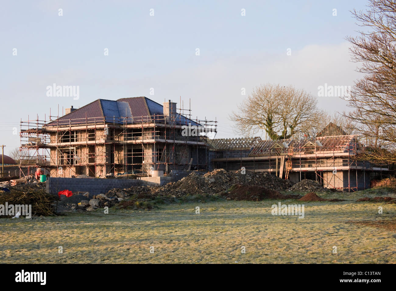 Wales, UK, Europe. Scaffolding on a large new house being built on a green field site Stock Photo