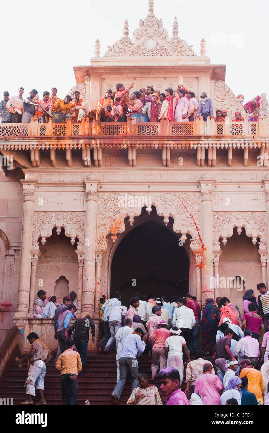 People celebrating Holi festival in a temple, Barsana, Uttar Pradesh, India Stock Photo