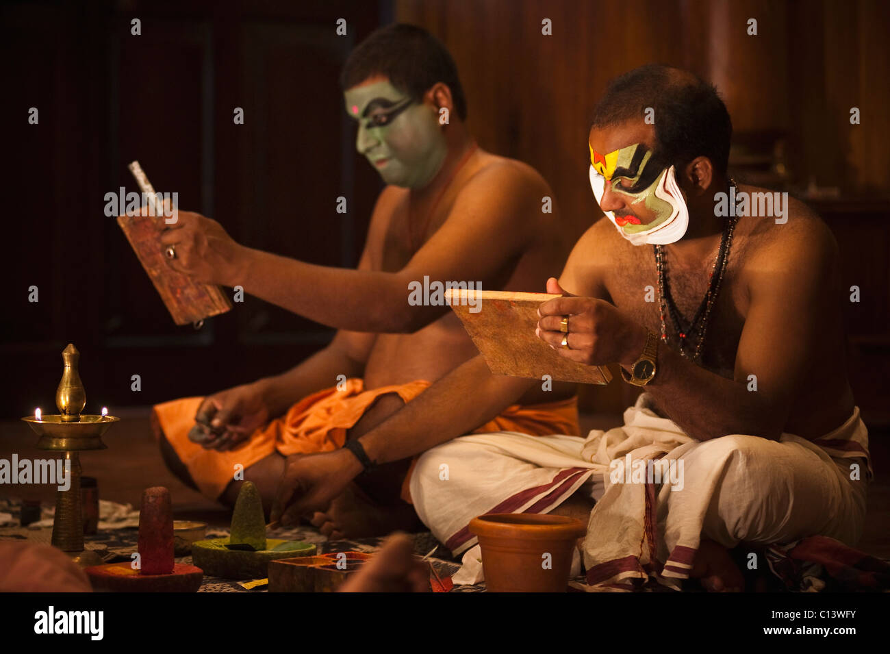 Men applying make-up for Kathakali performance, Kochi, Kerala, India Stock Photo