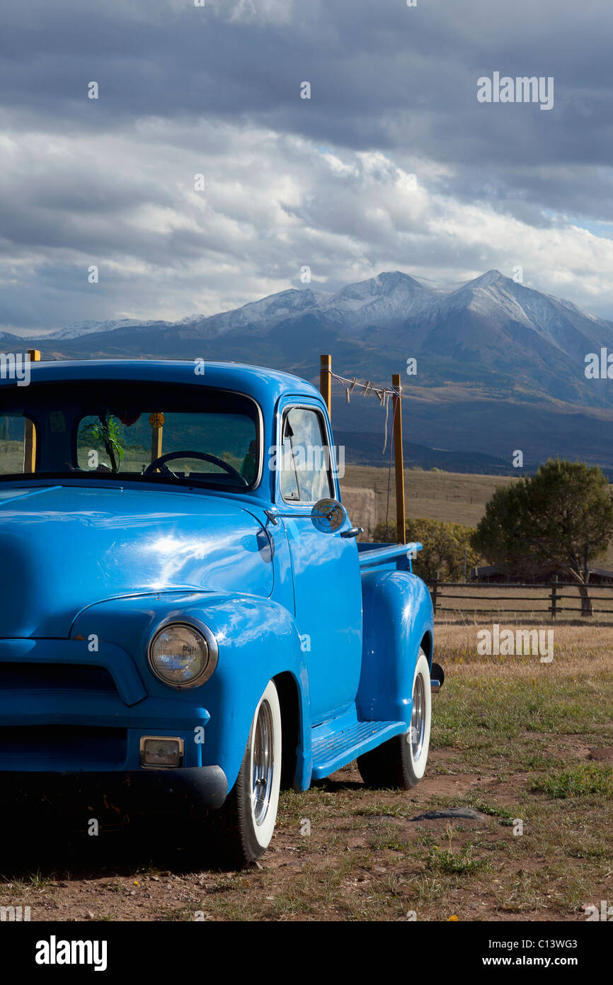 USA, Colorado, Carbondale, Blue vintage car, mount Sopris in background