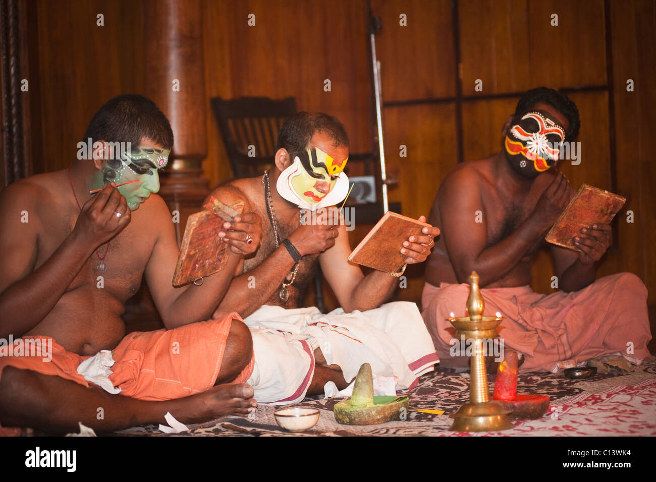 Men applying make-up for Kathakali performance, Kochi, Kerala, India Stock Photo