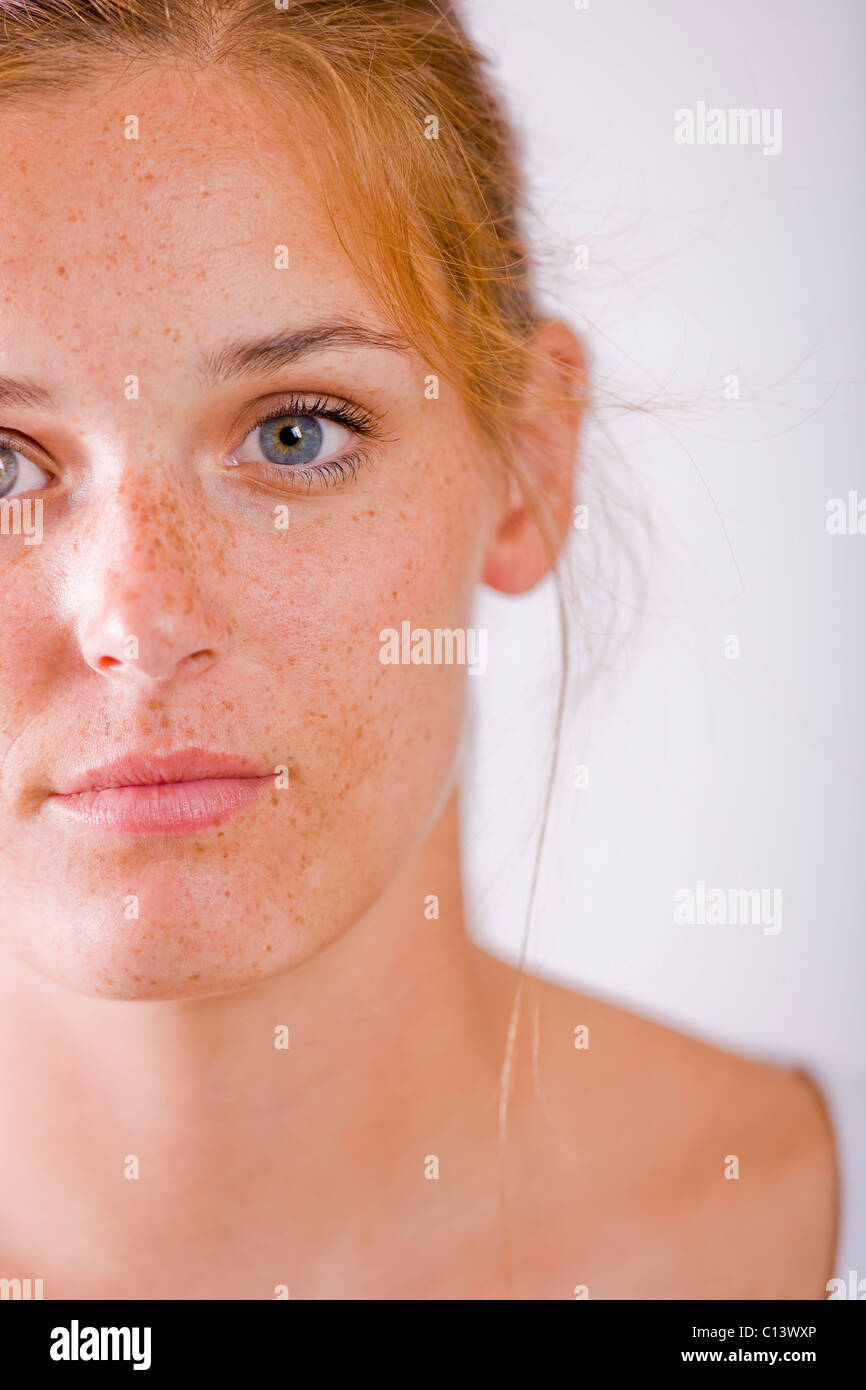 Studio portrait of young woman with freckles Stock Photo