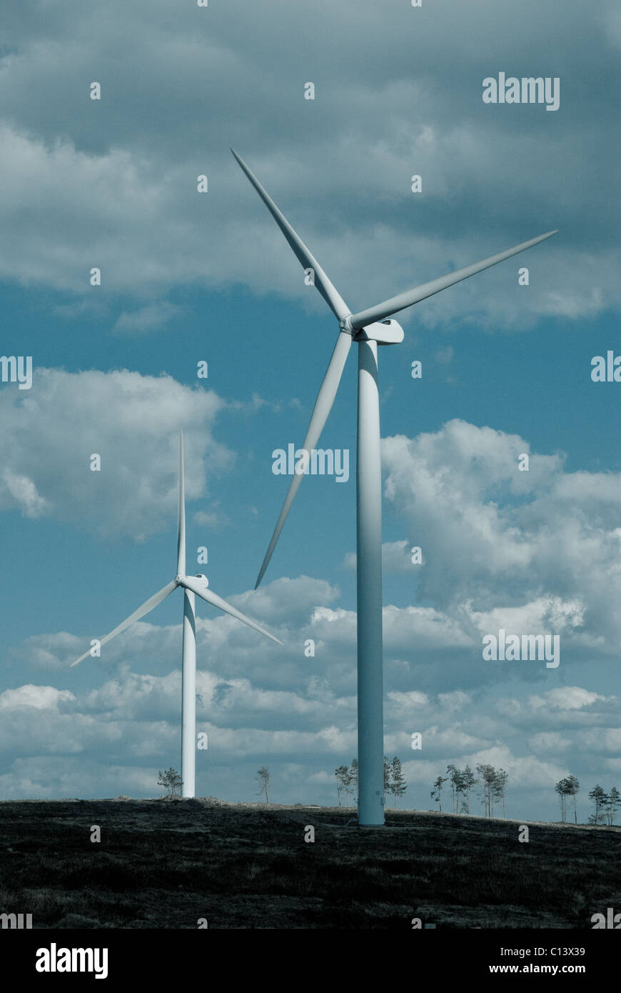 Wind turbine in the back light of the sun with blue sky and clouds ...