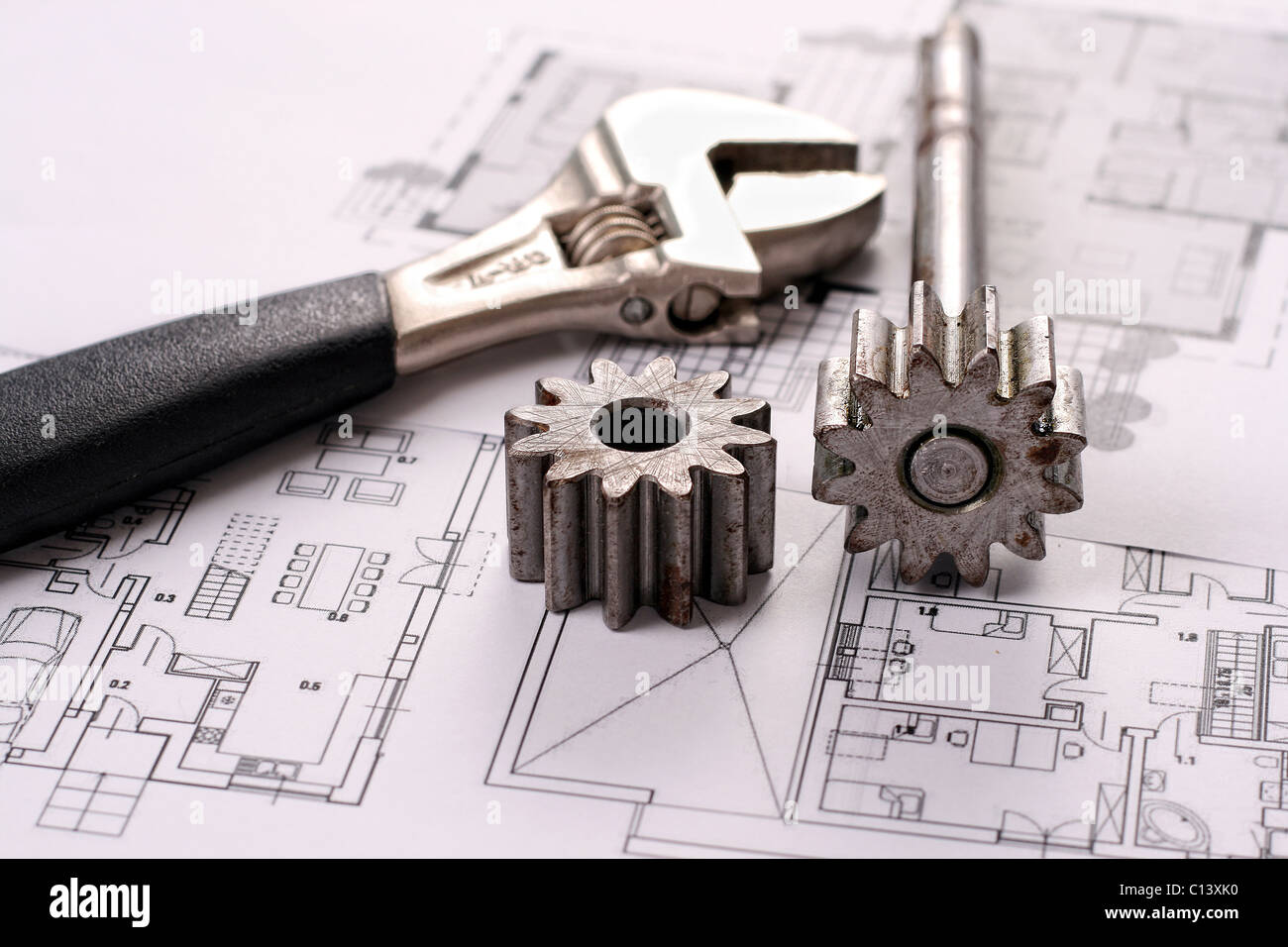 Tools on Blueprints including sprocked stacks and monkey wrench. House plans printed on white paper. Stock Photo