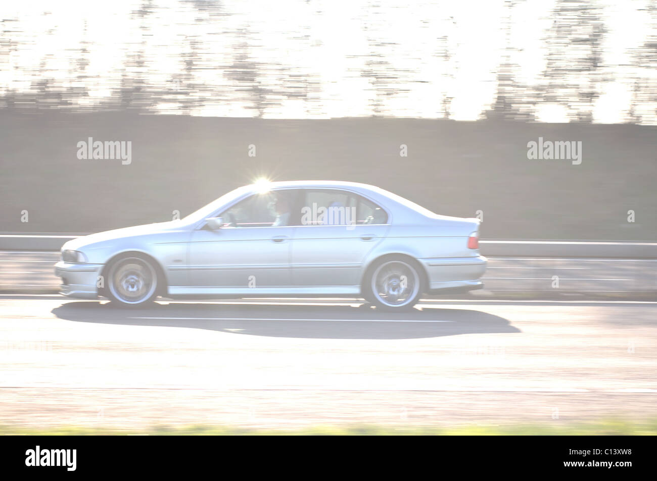 High key image of car at speed on motorway Stock Photo