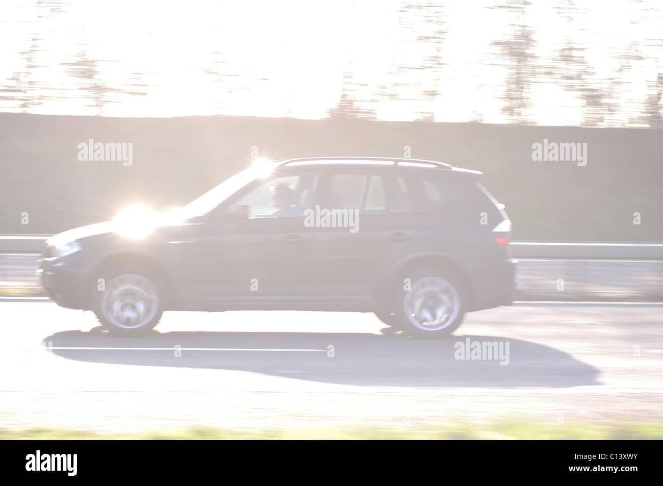 High key image of car at speed on motorway Stock Photo