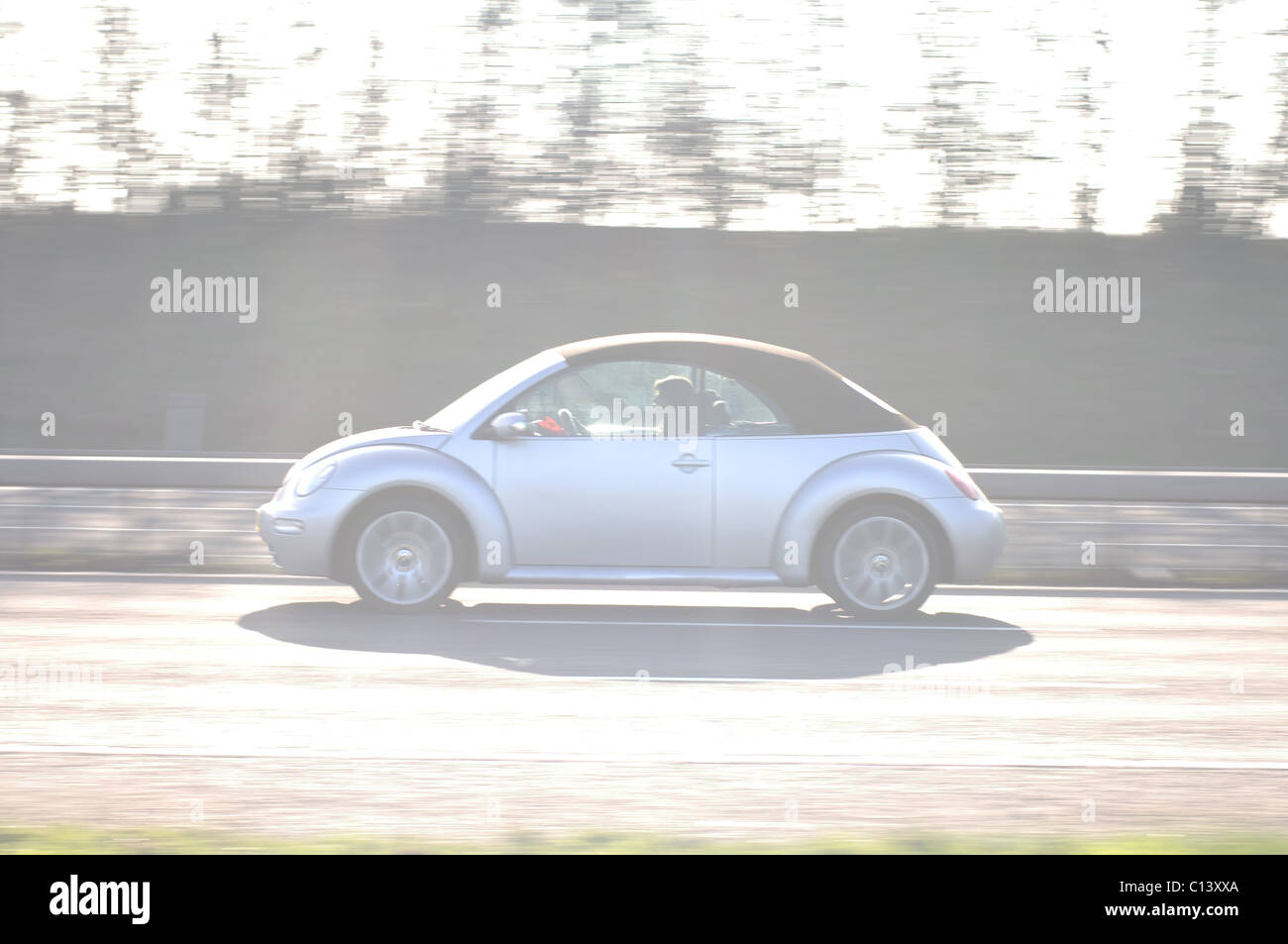 High key image of New Beetle car at speed on M40 motorway Stock Photo