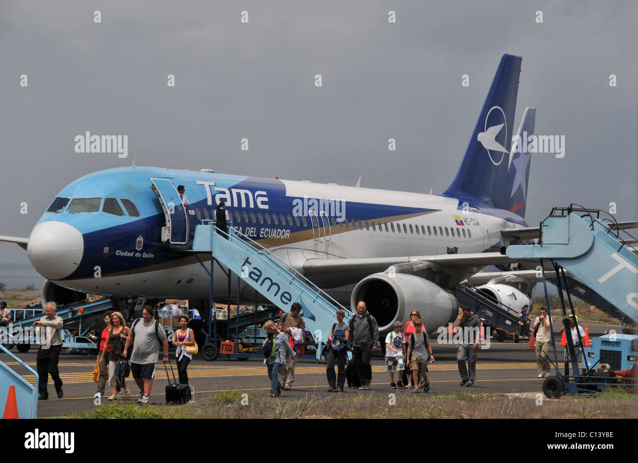 passengers leaving Tame airlines plane in Baltra airport Galapagos islands Ecuador Stock Photo