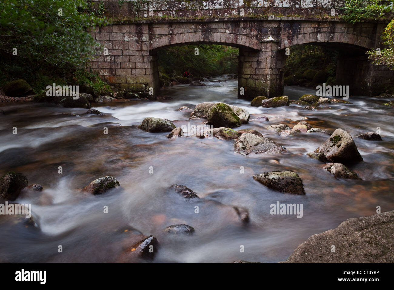 Old stone bridge crossing a flowing river on Dartmoor Stock Photo - Alamy