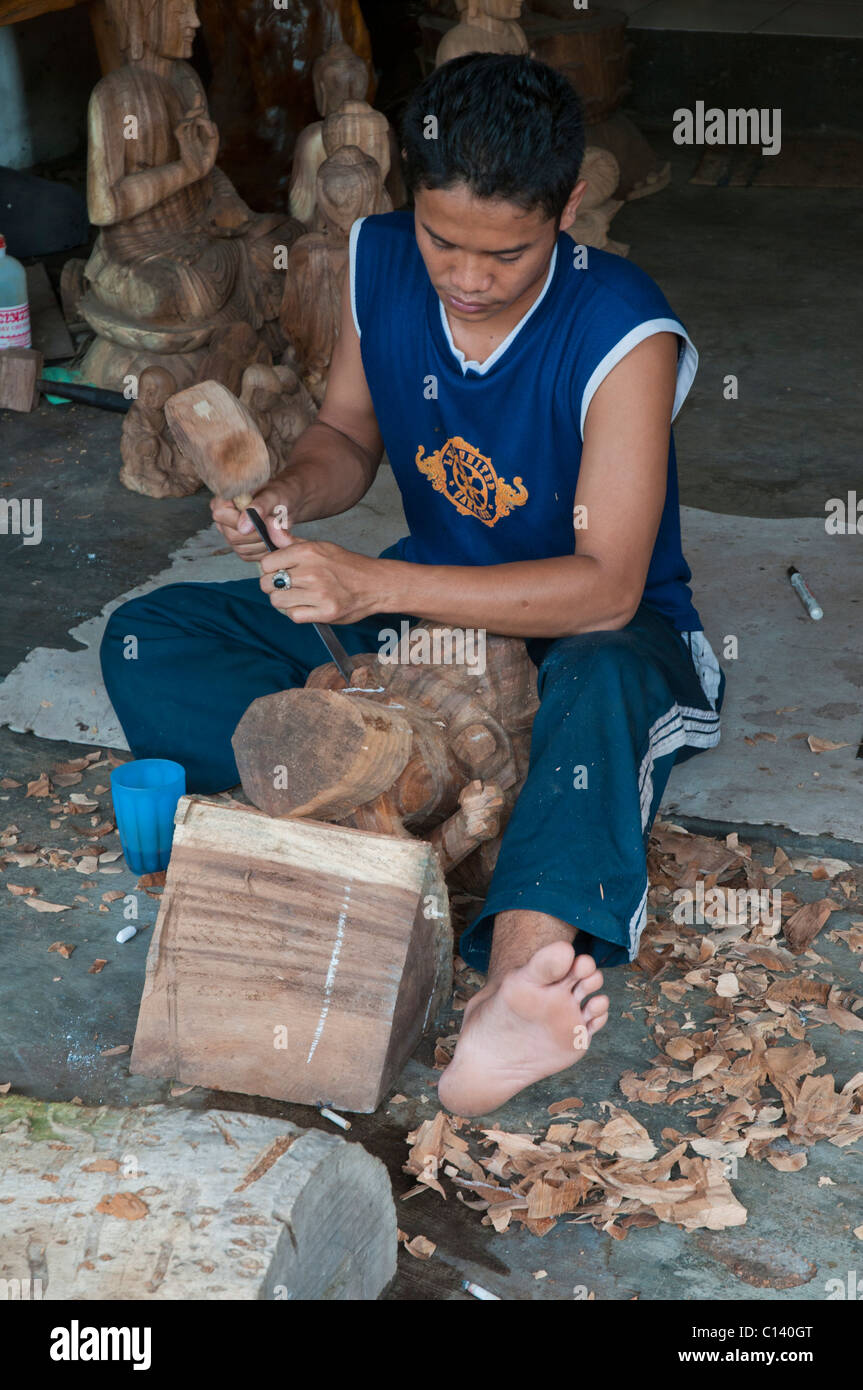 A woodcarver at work in the Balinese wood carvers village of Peliatan Stock Photo