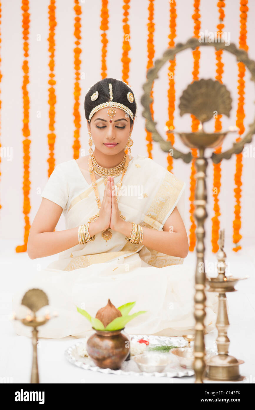 Bride praying in traditional South Indian dress Stock Photo