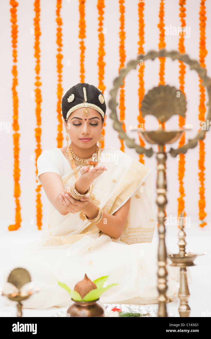 Bride praying in traditional South Indian dress Stock Photo