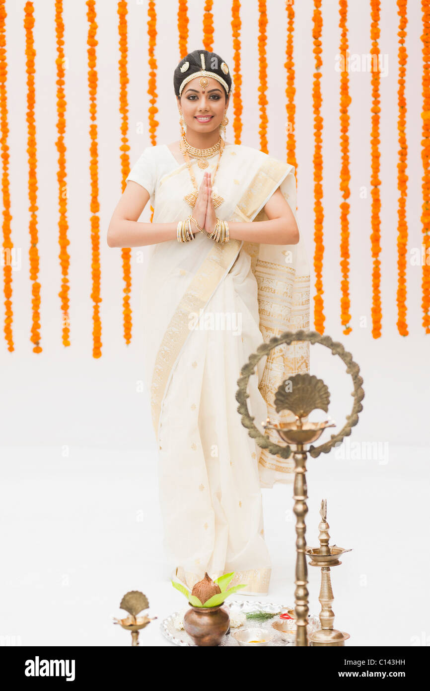 Bride praying in traditional South Indian dress at a wedding ceremony Stock Photo