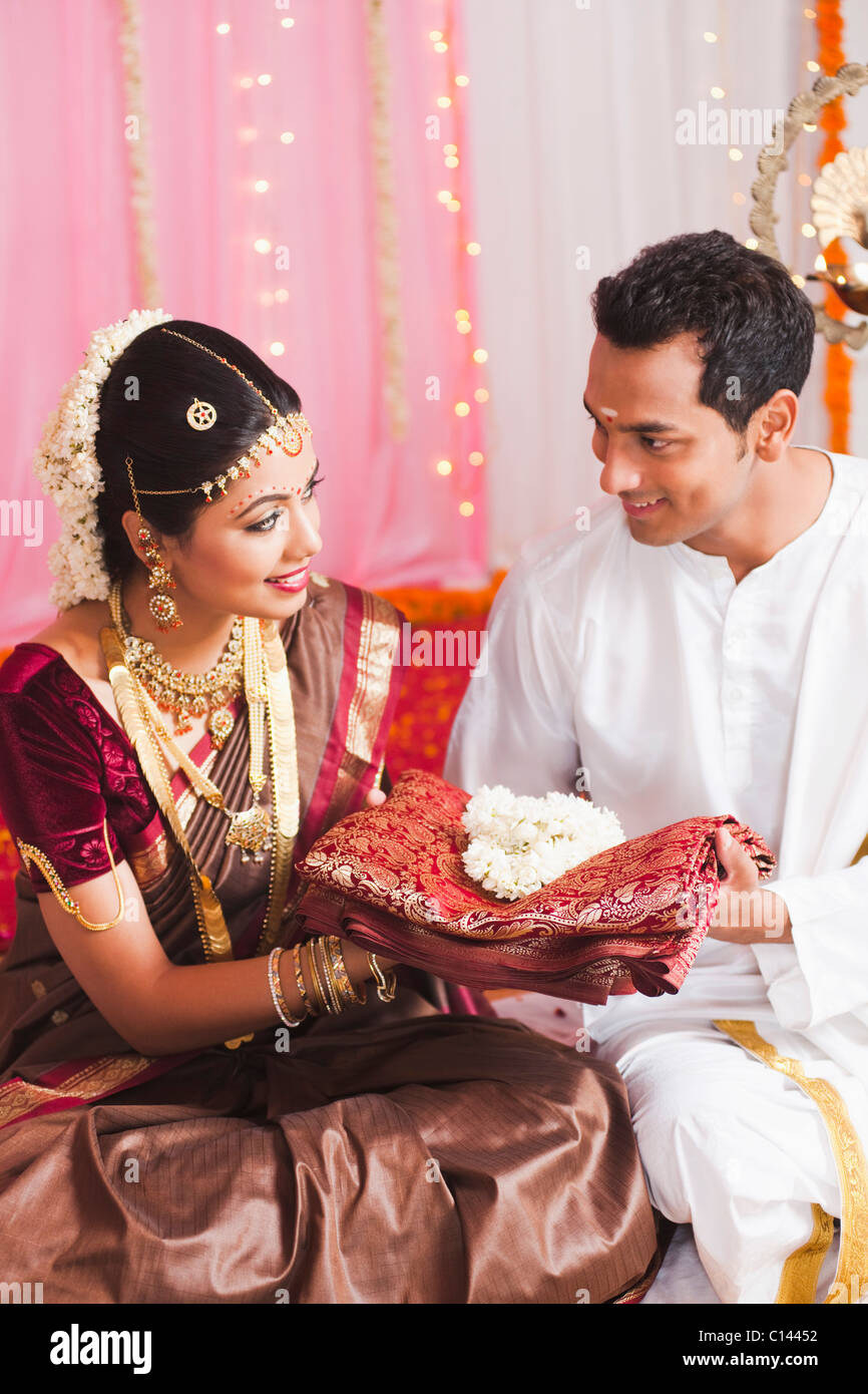 Bridegroom giving a sari to the bride at the South Indian wedding ceremony Stock Photo