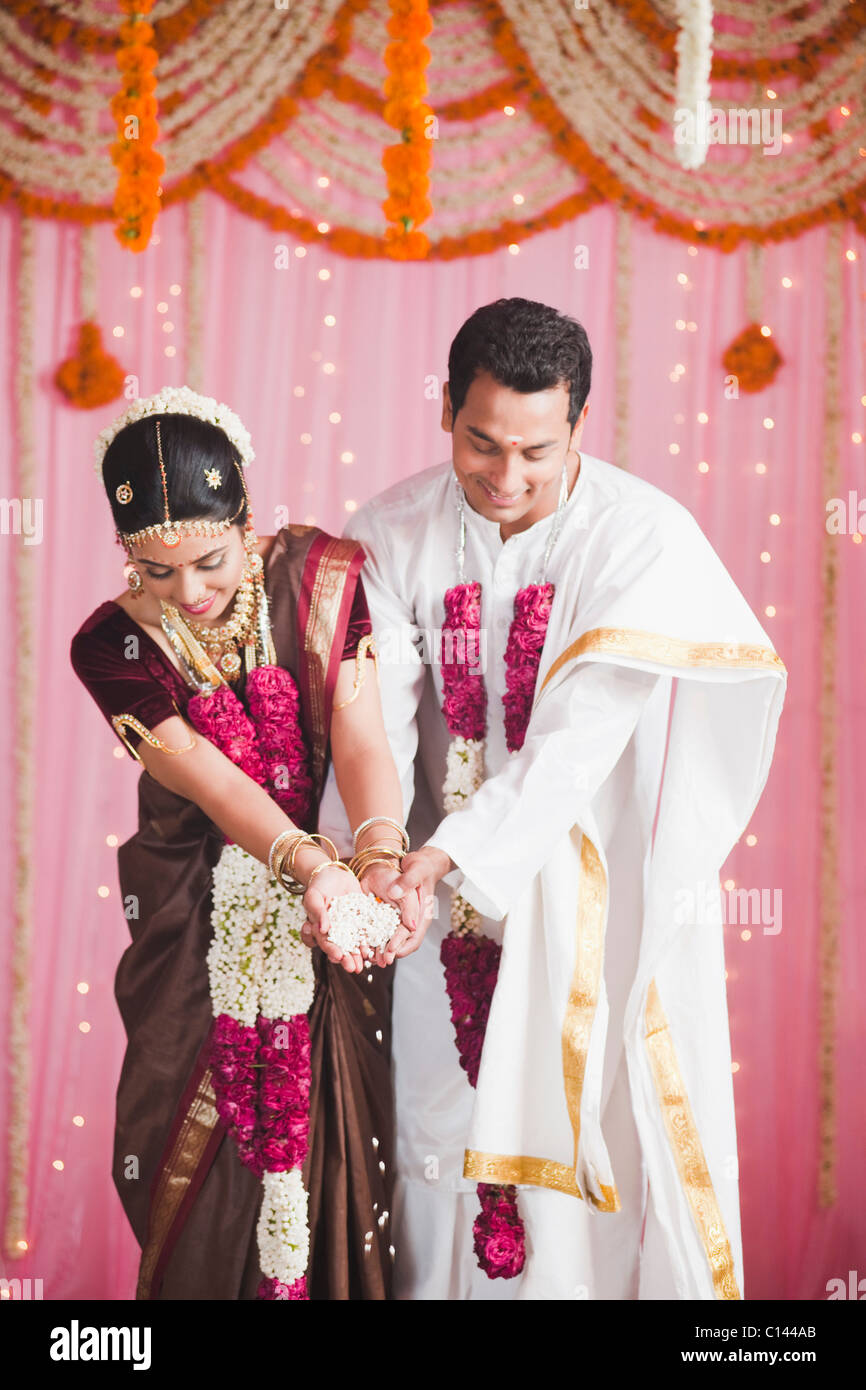 Bride and bridegroom performing a religious ceremony during south Indian wedding Stock Photo