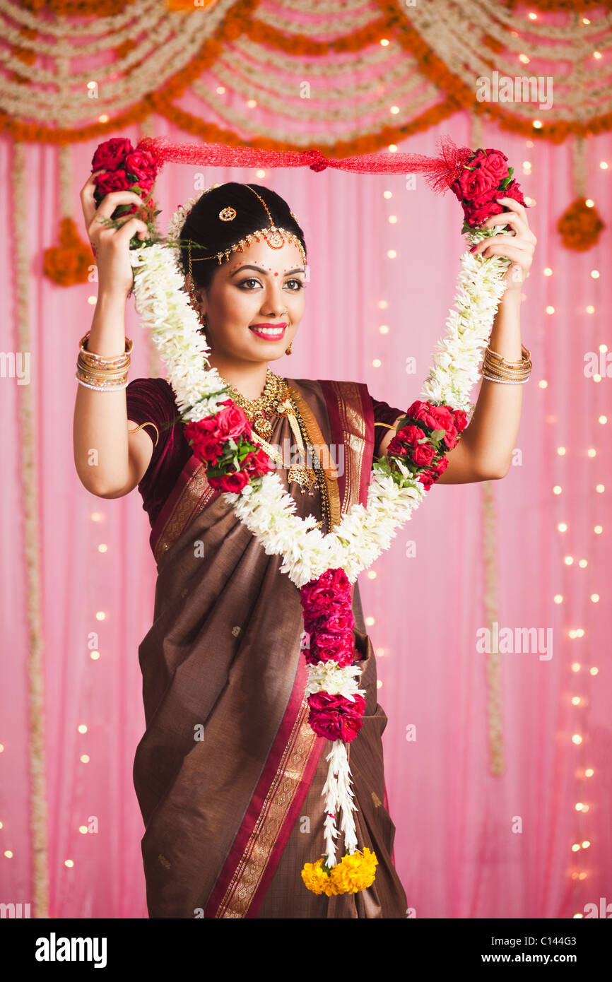 Bride In Traditional South Indian Dress Holding A Garland And