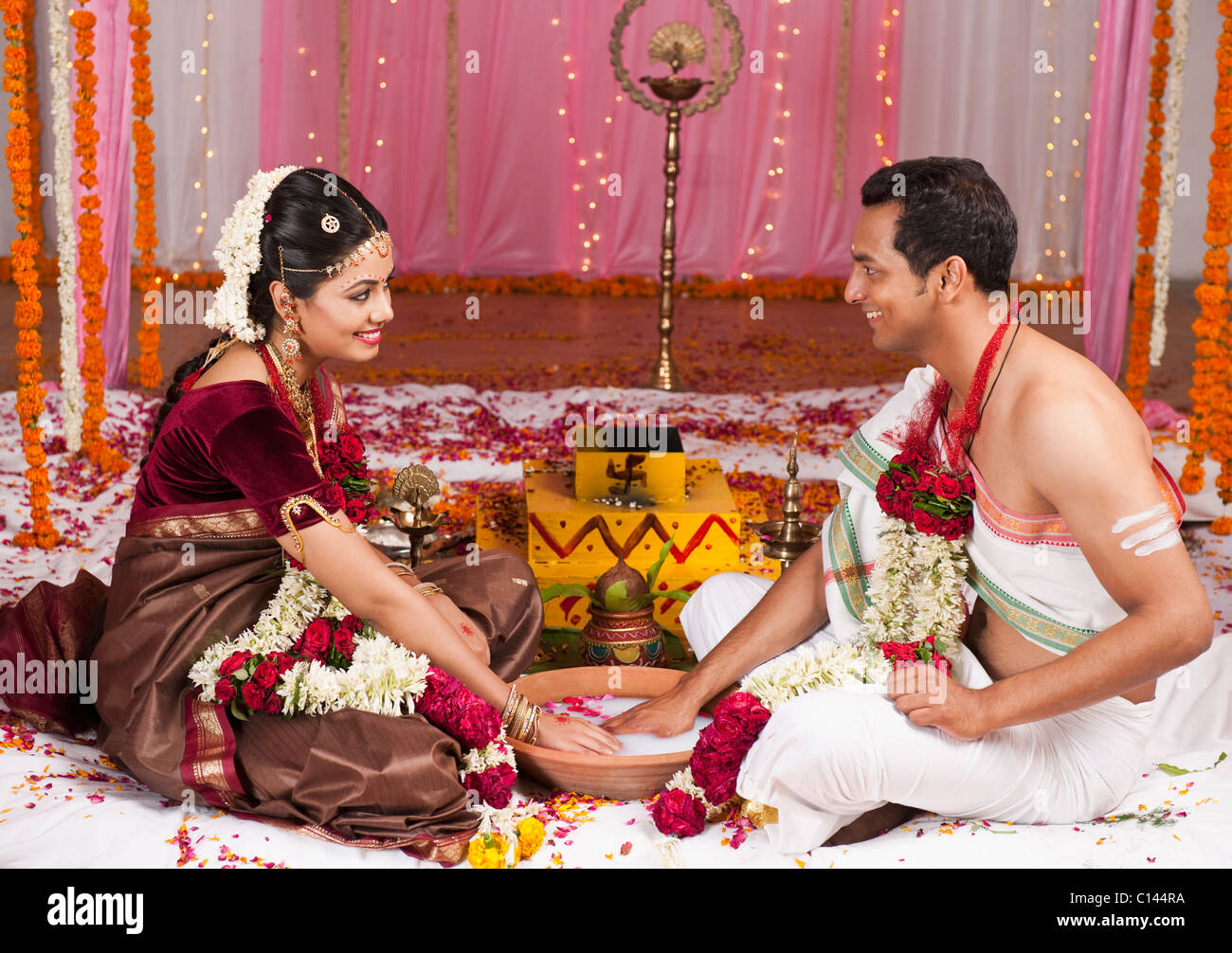 Newlywed couple playing Kangana Jua during South Indian wedding ceremony Stock Photo