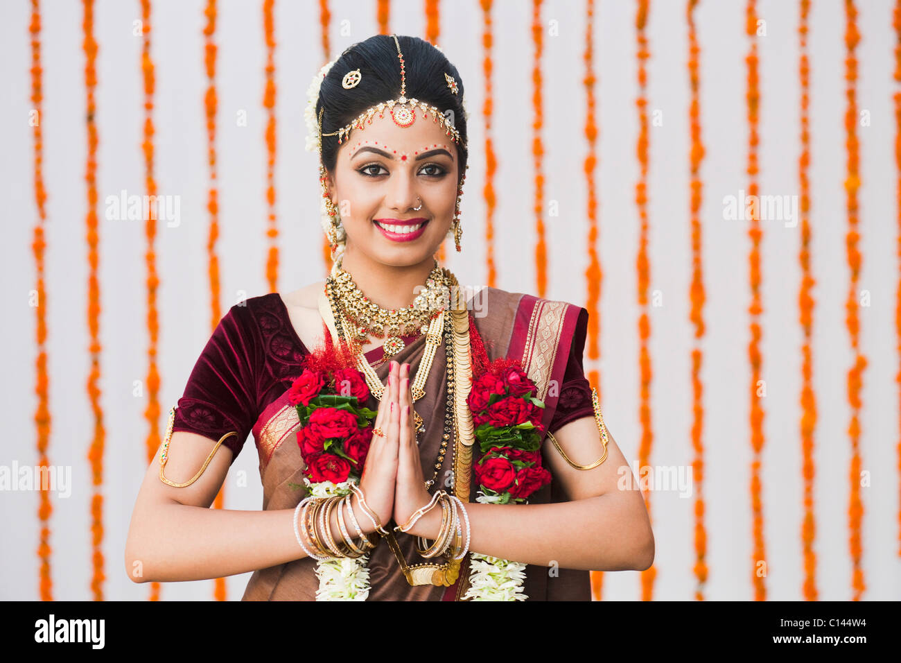 Portrait of a bride in traditional South Indian dress greeting Stock Photo